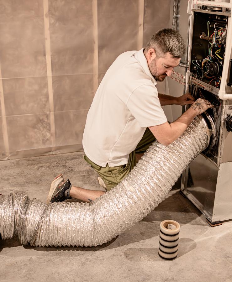 Man setting up duct blaster test machine