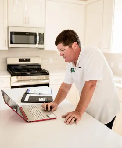 Man using laptop on counter