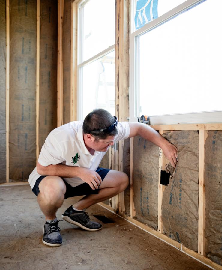 Man checking drywall